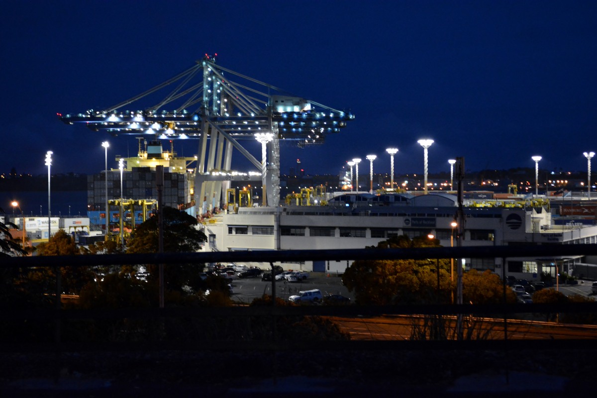 Container cranes and a cargo ship at Auckland’s Fergusson Container Terminal at night, photographed in February 2014.
