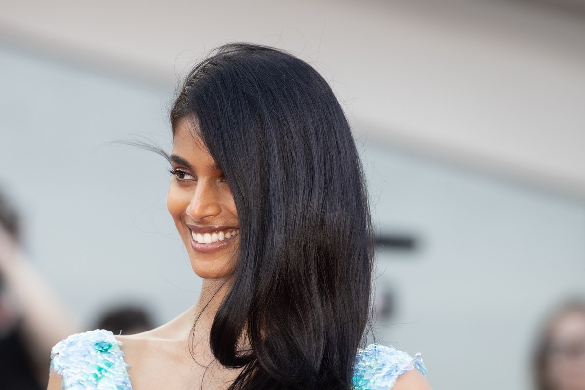 Bhavitha Mandava smiling, with long dark hair and a pale blue embellished dress, at the Venice Film Festival.
