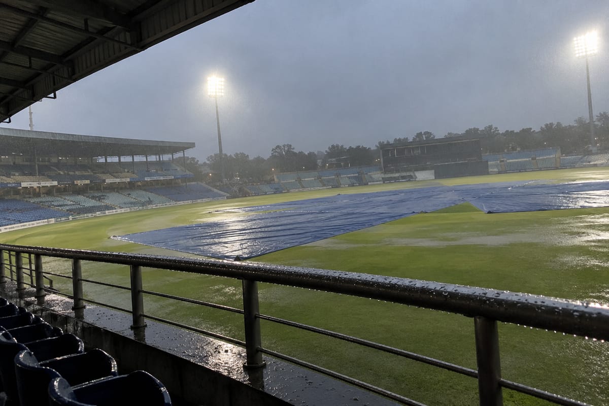 Representational AI illustration of an empty cricket ground under rain covers; not a photograph of the Bengaluru match.