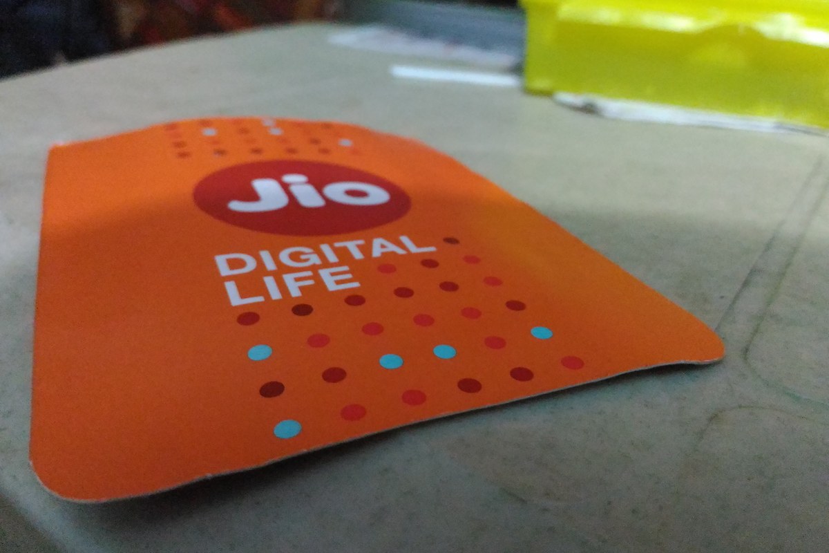 An orange Jio SIM card holder with the red Jio logo and the words Digital Life lying on a table.